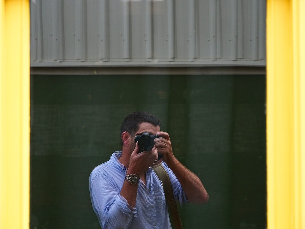 Jason dithers over the purchase, a distorted reflection in a pane of vintage glass — definitely not a fault in the G9